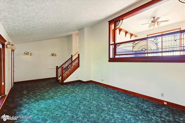 43725 Ross Dr, Soldotna, AK 99669 - carpeted empty room featuring a ceiling fan, a textured ceiling, and stairs