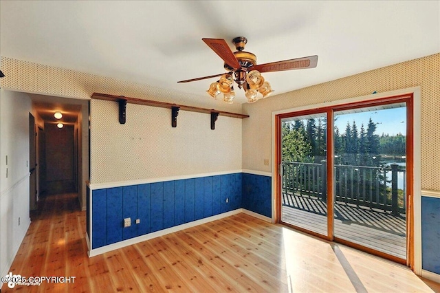 43725 Ross Dr, Soldotna, AK 99669 - spare room featuring hardwood / wood-style floors, ceiling fan, and wainscoting