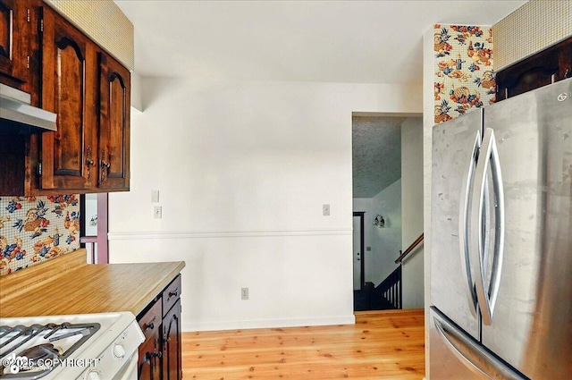 43725 Ross Dr, Soldotna, AK 99669 - kitchen with freestanding refrigerator, white range with gas stovetop, and light wood finished floors