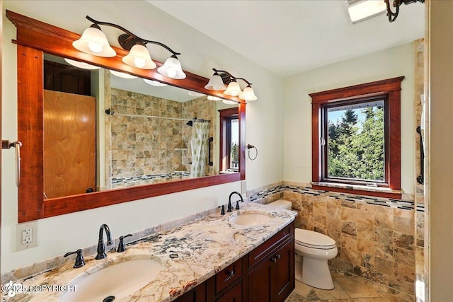 43725 Ross Dr, Soldotna, AK 99669 - bathroom with double vanity, tile walls, a tile shower, and wainscoting