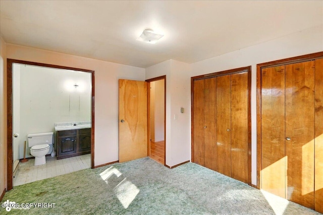 43725 Ross Dr, Soldotna, AK 99669 - unfurnished bedroom with two closets, connected bathroom, and carpet floors