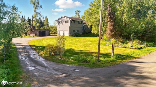43725 Ross Dr, Soldotna, AK 99669 - view of grassy yard featuring driveway and an attached garage