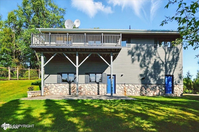 43725 Ross Dr, Soldotna, AK 99669 - back of property featuring a yard, stone siding, and a deck
