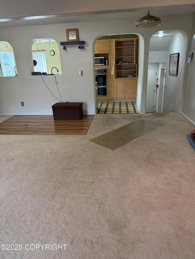 2090 Dimond Dr, Anchorage, AK 99507 - living room featuring arched walkways and carpet flooring