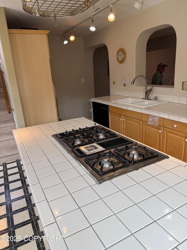 2090 Dimond Dr, Anchorage, AK 99507 - kitchen featuring arched walkways, stainless steel gas stovetop, black dishwasher, tile countertops, and light brown cabinets
