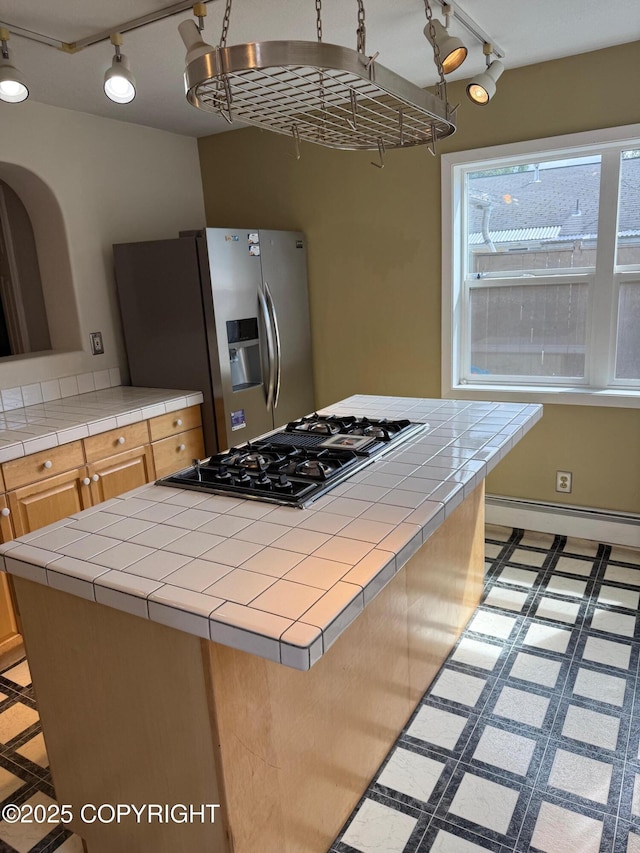 2090 Dimond Dr, Anchorage, AK 99507 - kitchen featuring stainless steel refrigerator with ice dispenser, rail lighting, black gas cooktop, tile countertops, and baseboard heating