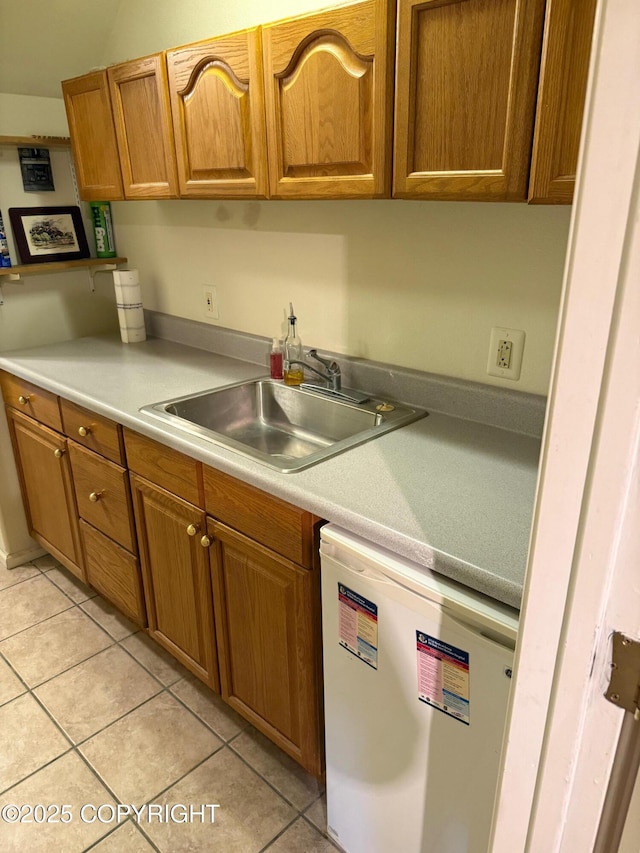 2090 Dimond Dr, Anchorage, AK 99507 - kitchen with dishwashing machine, light countertops, light tile patterned floors, and brown cabinets