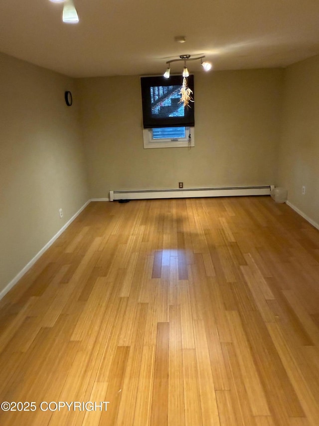 2090 Dimond Dr, Anchorage, AK 99507 - empty room featuring baseboard heating and light wood finished floors