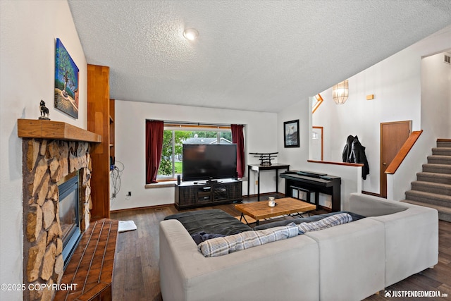 260 N Gloria St, Palmer, AK 99645 - living area with a textured ceiling, wood finished floors, a fireplace, and stairs