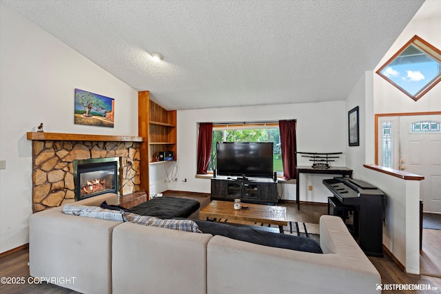 260 N Gloria St, Palmer, AK 99645 - living area with wood finished floors, vaulted ceiling, a textured ceiling, and a stone fireplace