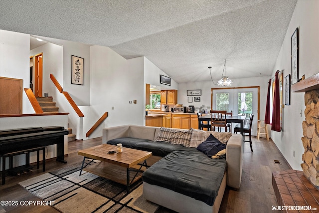 260 N Gloria St, Palmer, AK 99645 - living room featuring vaulted ceiling, a chandelier, a textured ceiling, wood finished floors, and stairway