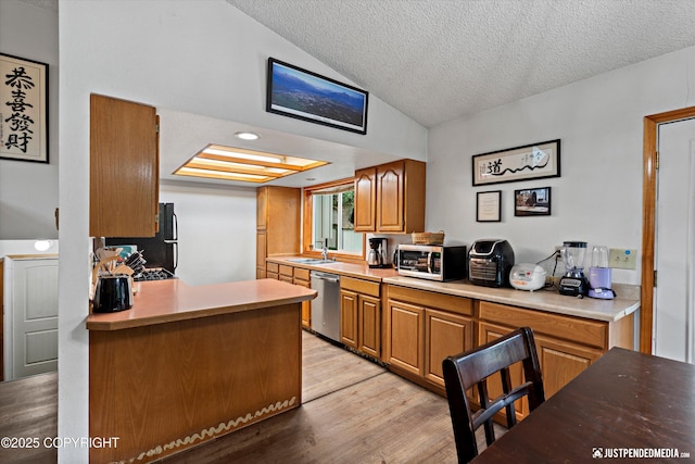 260 N Gloria St, Palmer, AK 99645 - kitchen with appliances with stainless steel finishes, lofted ceiling, a textured ceiling, light wood finished floors, and light countertops