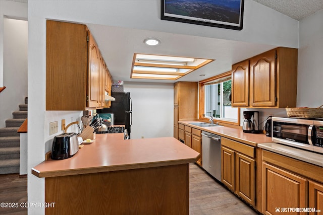 260 N Gloria St, Palmer, AK 99645 - kitchen featuring appliances with stainless steel finishes, light wood-type flooring, and light countertops