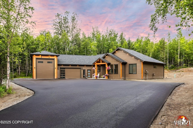 365 W Crestwood Ave, Wasilla, AK 99654 - view of front facade with driveway, an attached garage, roof with shingles, and board and batten siding