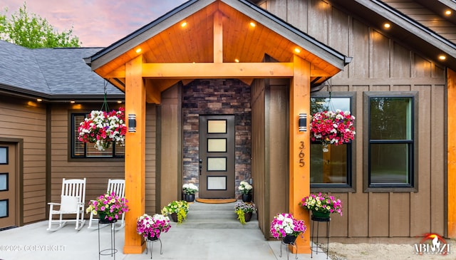 365 W Crestwood Ave, Wasilla, AK 99654 - property entrance featuring board and batten siding, a shingled roof, and stone siding