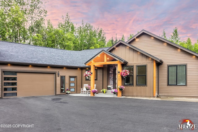 365 W Crestwood Ave, Wasilla, AK 99654 - view of front facade with board and batten siding, driveway, an attached garage, and roof with shingles