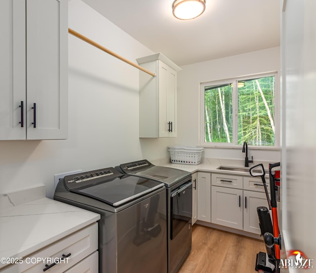365 W Crestwood Ave, Wasilla, AK 99654 - laundry area featuring cabinet space, independent washer and dryer, and light wood-style floors