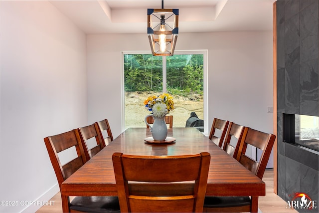 365 W Crestwood Ave, Wasilla, AK 99654 - dining space featuring a chandelier, light wood-style floors, and a raised ceiling