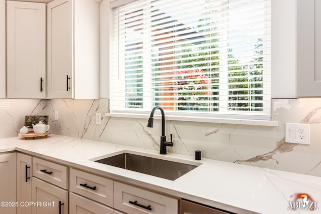 365 W Crestwood Ave, Wasilla, AK 99654 - kitchen with tasteful backsplash, light stone counters, and white cabinets