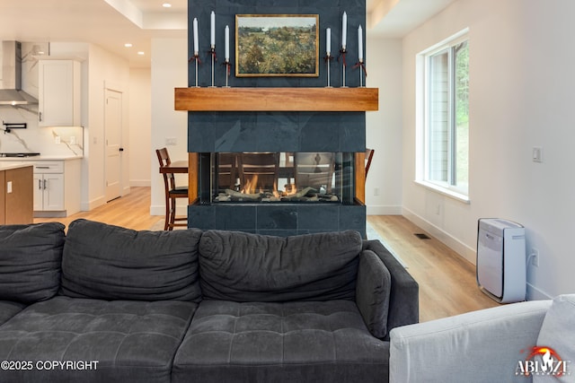 365 W Crestwood Ave, Wasilla, AK 99654 - living room featuring a multi sided fireplace, light wood finished floors, and recessed lighting