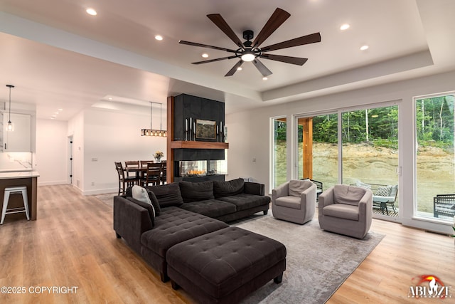 365 W Crestwood Ave, Wasilla, AK 99654 - living room with plenty of natural light, recessed lighting, a raised ceiling, light wood finished floors, and a ceiling fan