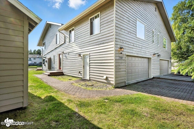 2350 Canary Ct, Anchorage, AK 99515 - view of side of property with an attached garage and a yard