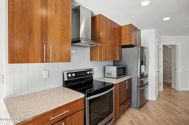 2350 Canary Ct, Anchorage, AK 99515 - kitchen featuring appliances with stainless steel finishes, wall chimney exhaust hood, brown cabinets, light wood finished floors, and recessed lighting