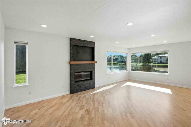 2350 Canary Ct, Anchorage, AK 99515 - unfurnished living room with a stone fireplace, wood finished floors, and recessed lighting