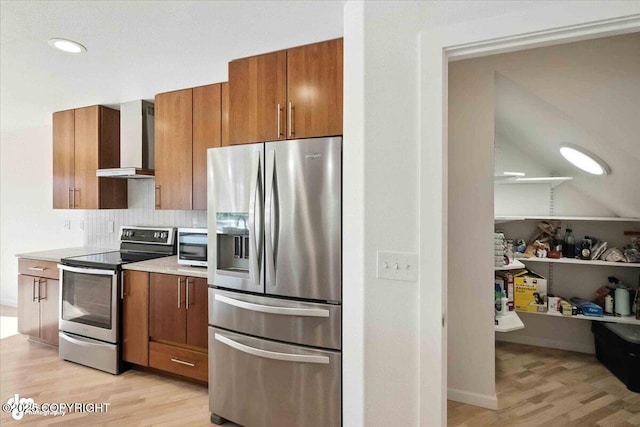 2350 Canary Ct, Anchorage, AK 99515 - kitchen featuring stainless steel appliances, wall chimney exhaust hood, light wood-style floors, brown cabinetry, and light countertops