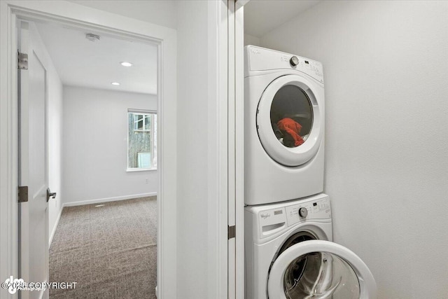 2350 Canary Ct, Anchorage, AK 99515 - laundry area featuring stacked washing machine and dryer, carpet floors, and recessed lighting