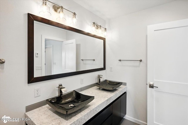 2350 Canary Ct, Anchorage, AK 99515 - bathroom featuring double vanity and baseboards
