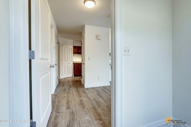 2350 Canary Ct, Anchorage, AK 99515 - corridor featuring light wood-type flooring and baseboards