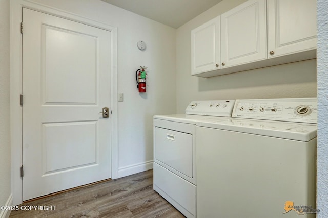 2350 Canary Ct, Anchorage, AK 99515 - laundry area with separate washer and dryer, light wood-style floors, and cabinet space