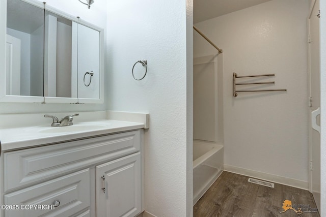 2350 Canary Ct, Anchorage, AK 99515 - full bath with wood finished floors, vanity, and shower / bath combination