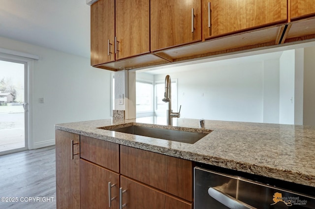 2350 Canary Ct, Anchorage, AK 99515 - kitchen featuring light stone countertops, dishwasher, wood finished floors, and healthy amount of natural light