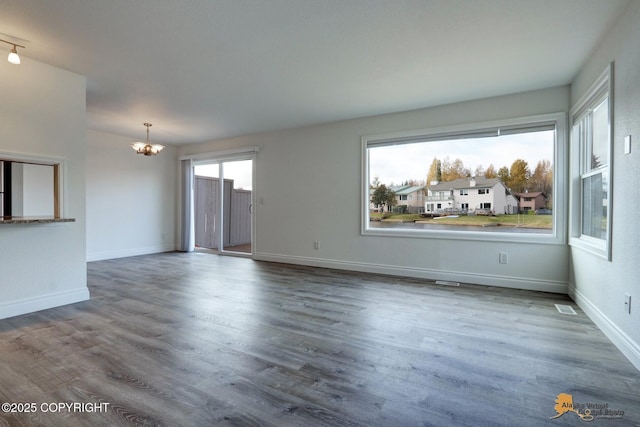 2350 Canary Ct, Anchorage, AK 99515 - unfurnished living room featuring a chandelier and wood finished floors