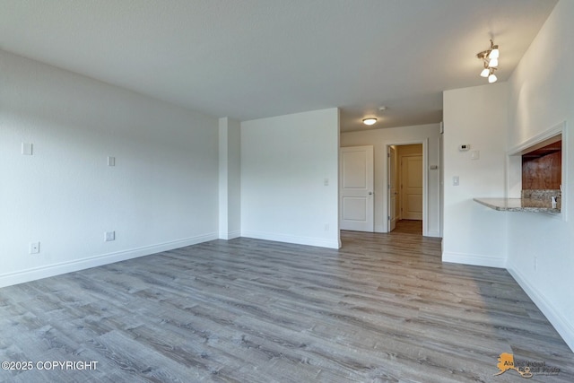 2350 Canary Ct, Anchorage, AK 99515 - unfurnished living room with wood finished floors and baseboards