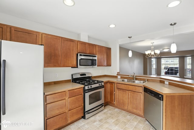 133 Matthew Paul Way, Anchorage, AK 99504 - kitchen featuring stainless steel appliances, a peninsula, a chandelier, recessed lighting, and hanging light fixtures