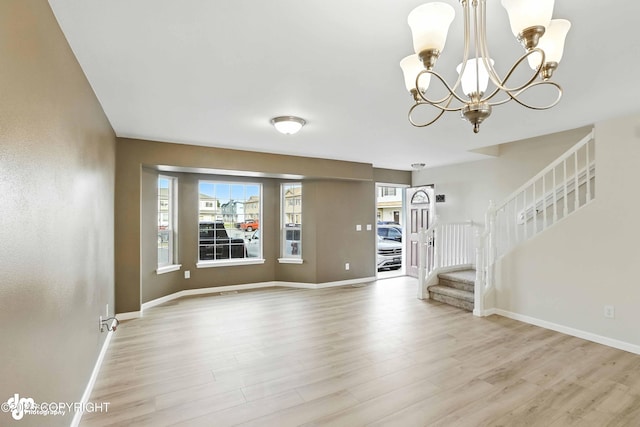 133 Matthew Paul Way, Anchorage, AK 99504 - unfurnished living room with a chandelier, stairway, and light wood finished floors