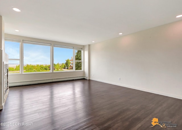 1414 W 7th Ave # 2, Anchorage, AK 99501 - unfurnished room featuring a baseboard heating unit, dark wood-style flooring, and recessed lighting