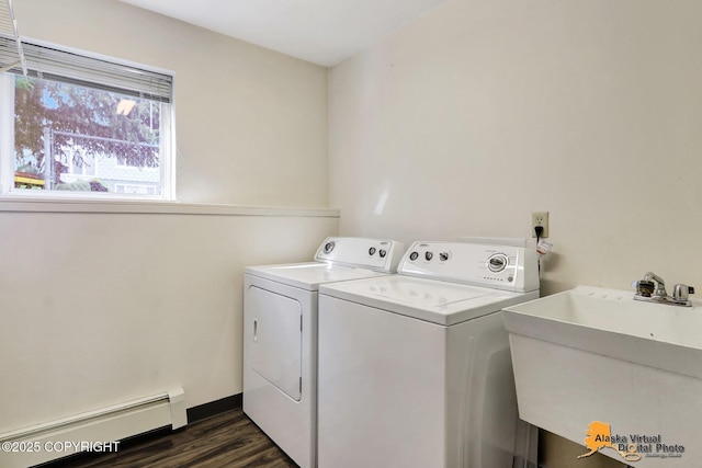 1414 W 7th Ave # 2, Anchorage, AK 99501 - laundry area featuring a baseboard radiator, washing machine and dryer, and dark wood-type flooring