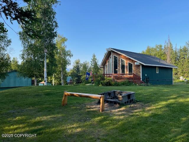 3021 N Arctic Fox Dr, Wasilla, AK 99654 - view of green lawn featuring a deck