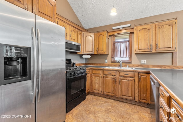 3021 N Arctic Fox Dr, Wasilla, AK 99654 - kitchen featuring stainless steel appliances, lofted ceiling, a textured ceiling, and brown cabinetry