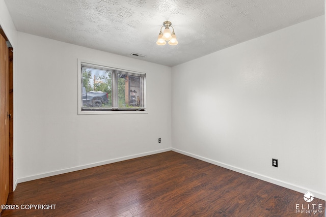 3021 N Arctic Fox Dr, Wasilla, AK 99654 - spare room featuring wood finished floors, a textured ceiling, and a chandelier