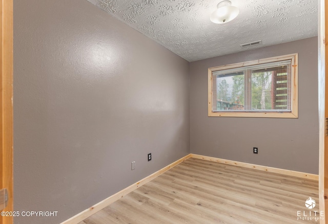 3021 N Arctic Fox Dr, Wasilla, AK 99654 - unfurnished room with light wood-style flooring and a textured ceiling