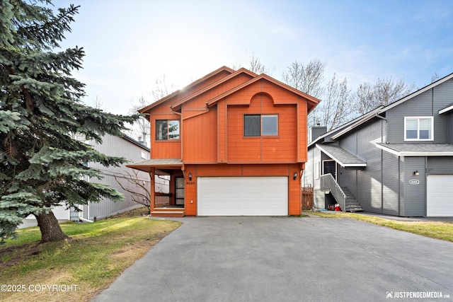 4060 Defiance St, Anchorage, AK 99504 - view of front of property with asphalt driveway and a garage