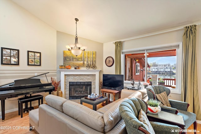 4060 Defiance St, Anchorage, AK 99504 - living room featuring light wood-style floors, lofted ceiling, a stone fireplace, and a chandelier