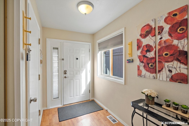 4060 Defiance St, Anchorage, AK 99504 - foyer entrance with wood finished floors and healthy amount of natural light