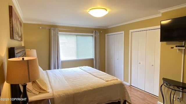 4060 Defiance St, Anchorage, AK 99504 - bedroom with multiple closets, wood finished floors, and ornamental molding