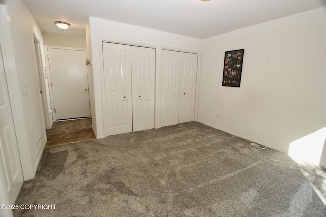 11613 Birch Knoll Loop, Anchorage, AK 99515 - unfurnished bedroom with two closets and carpet floors